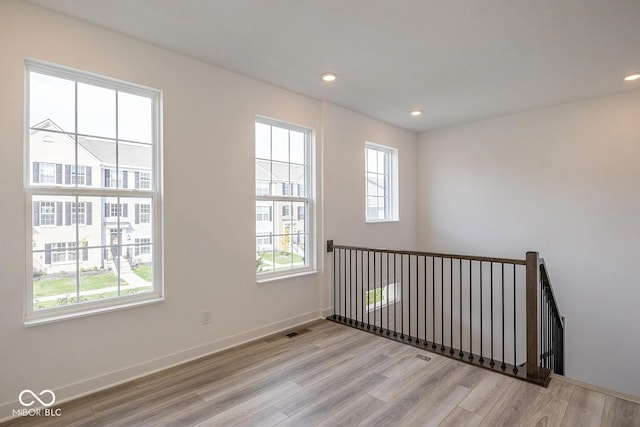 unfurnished room featuring light hardwood / wood-style flooring and a wealth of natural light