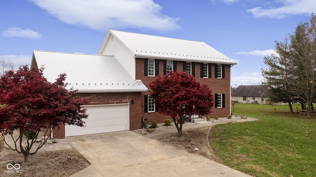 colonial house with a front yard and a garage