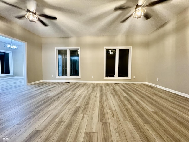 unfurnished living room featuring a textured ceiling and light wood-type flooring