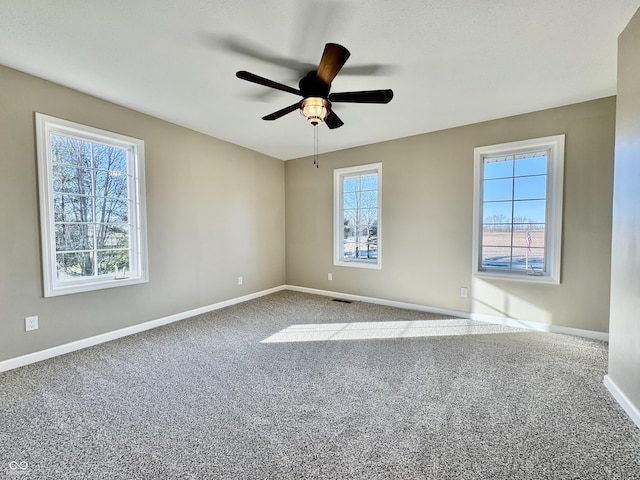 spare room with carpet flooring, plenty of natural light, and ceiling fan