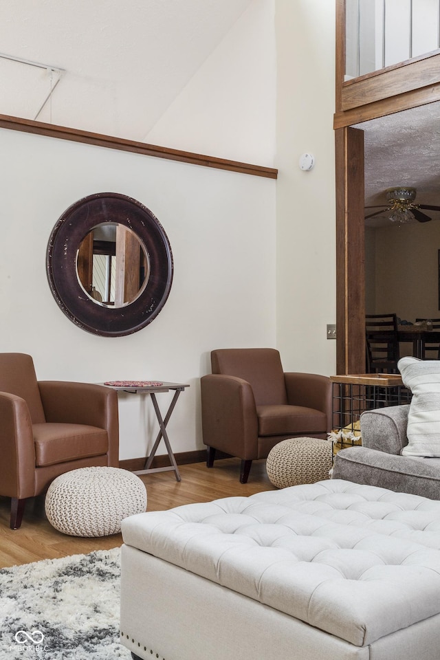 living room featuring ceiling fan and wood-type flooring