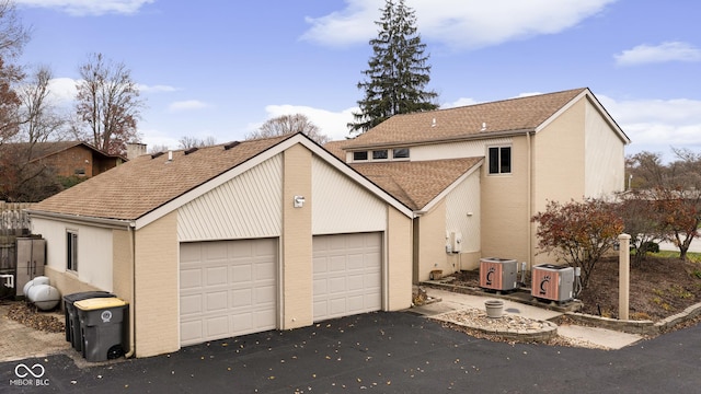 view of front facade with central AC and a garage