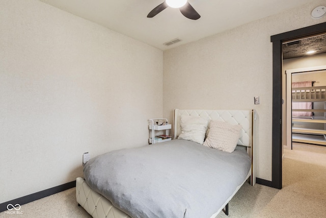 bedroom with ceiling fan and light carpet