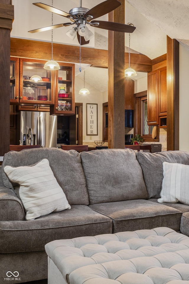 living room featuring ceiling fan and lofted ceiling