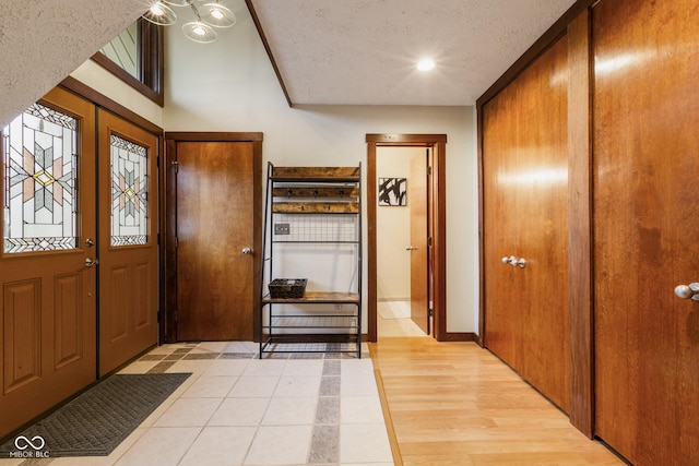 foyer featuring a textured ceiling and light hardwood / wood-style flooring