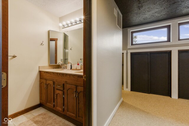 bathroom with vanity and a textured ceiling