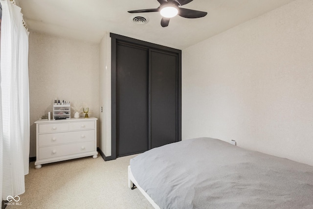 bedroom featuring ceiling fan and light carpet