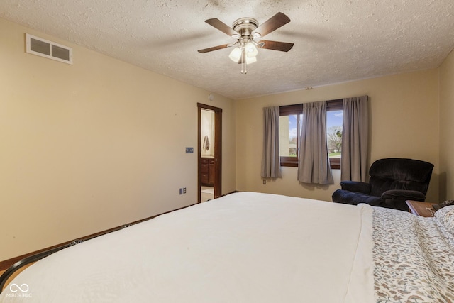 bedroom with a textured ceiling and ceiling fan