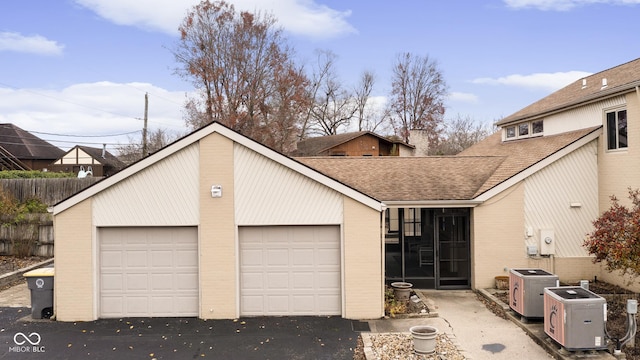 view of front of property with ac unit and a garage