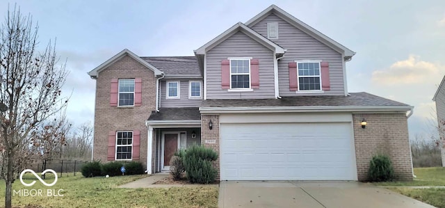 view of front property with a front yard and a garage