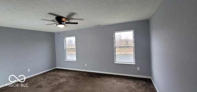 carpeted spare room featuring a textured ceiling and ceiling fan