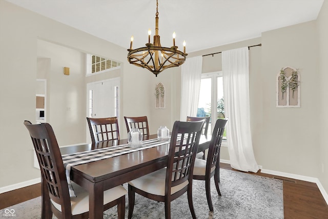 dining room featuring a notable chandelier and dark hardwood / wood-style floors