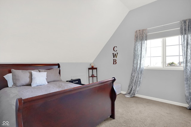 bedroom with carpet flooring and lofted ceiling