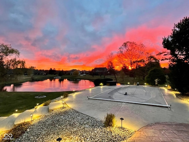 pool at dusk with a water view