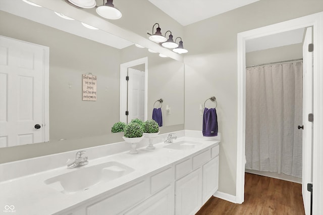 bathroom with a shower with shower curtain, hardwood / wood-style floors, and vanity