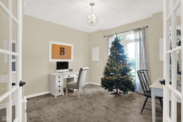 carpeted office space featuring french doors and an inviting chandelier