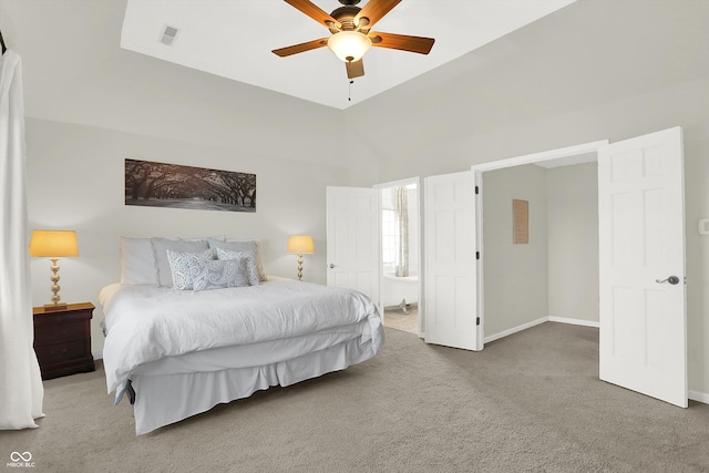 carpeted bedroom featuring connected bathroom, ceiling fan, and vaulted ceiling