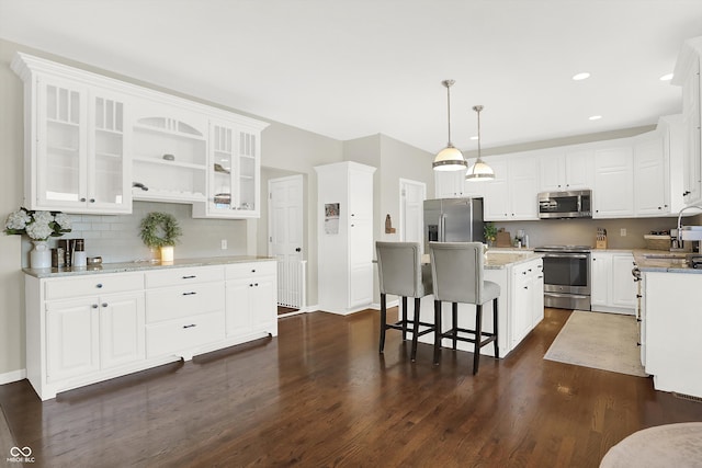 kitchen with white cabinetry, a kitchen island, and appliances with stainless steel finishes