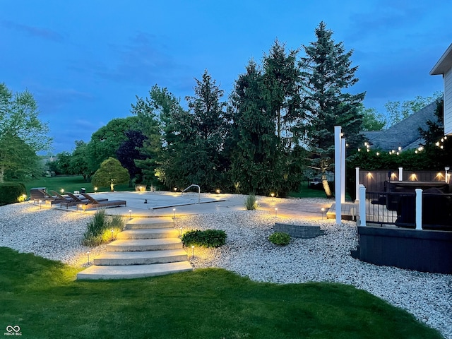 yard at dusk featuring a fire pit