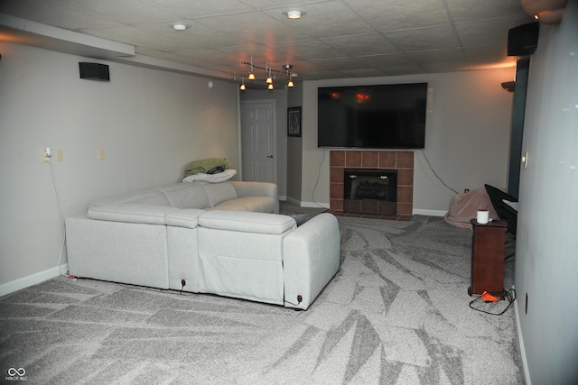 carpeted living room with a tile fireplace