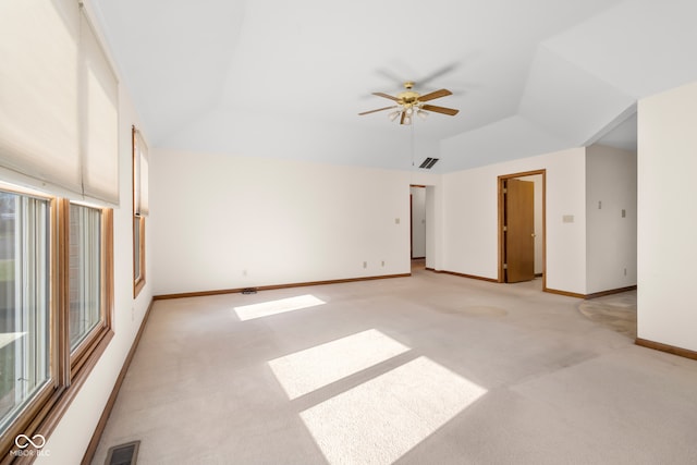 carpeted empty room with ceiling fan and vaulted ceiling