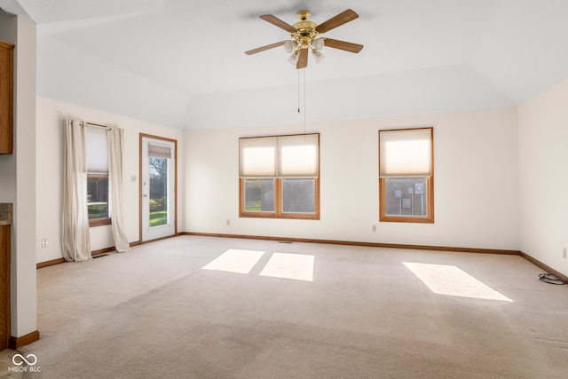 unfurnished room with ceiling fan, light colored carpet, and lofted ceiling