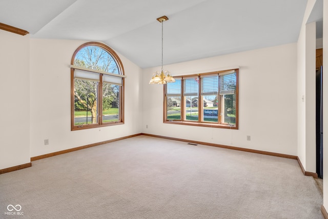 spare room with light carpet, vaulted ceiling, and an inviting chandelier