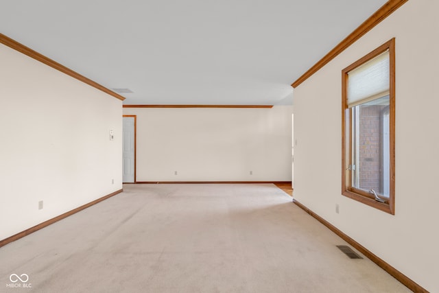 spare room featuring light carpet and crown molding