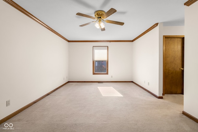 carpeted empty room with ceiling fan and ornamental molding