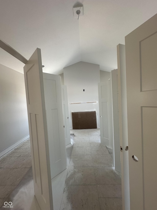 hall featuring vaulted ceiling