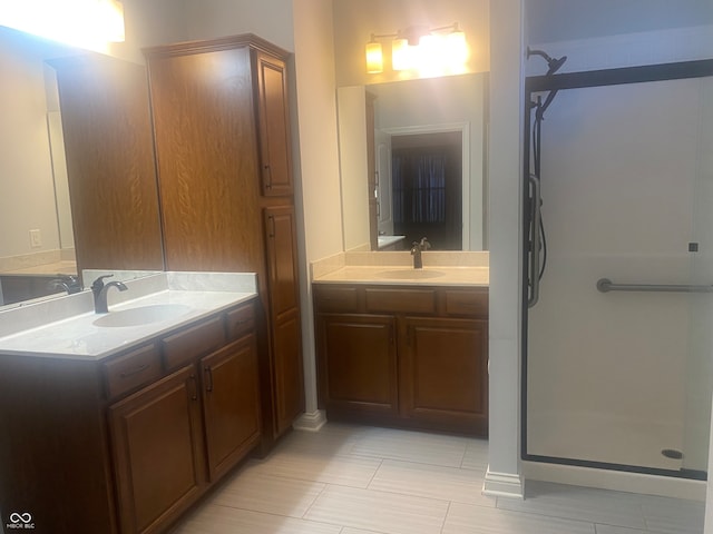 bathroom with a shower with door and vanity