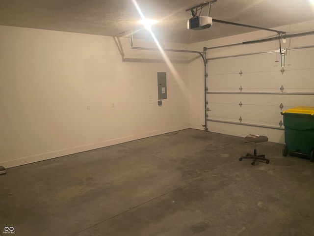 garage featuring electric panel and a garage door opener