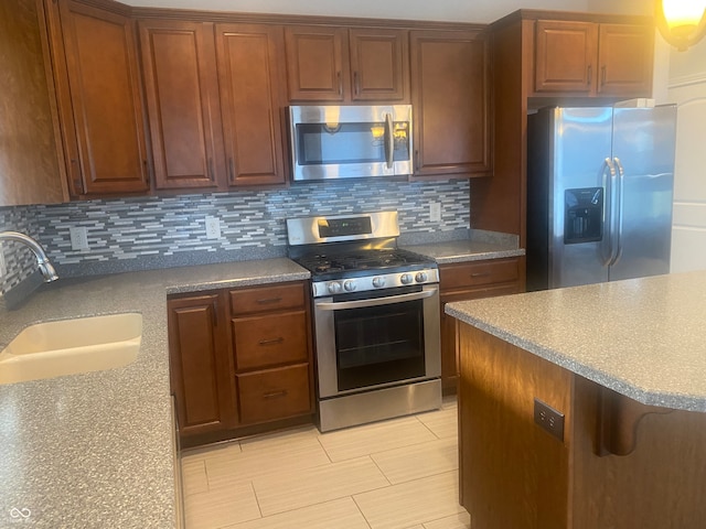 kitchen featuring backsplash, sink, and stainless steel appliances