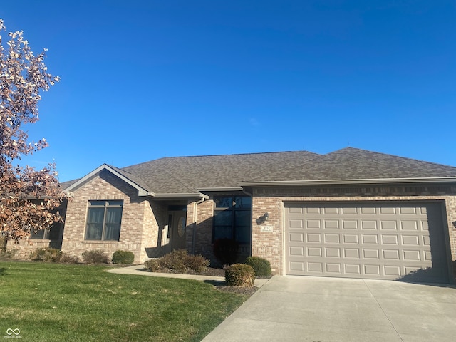 view of front of property featuring a garage and a front yard