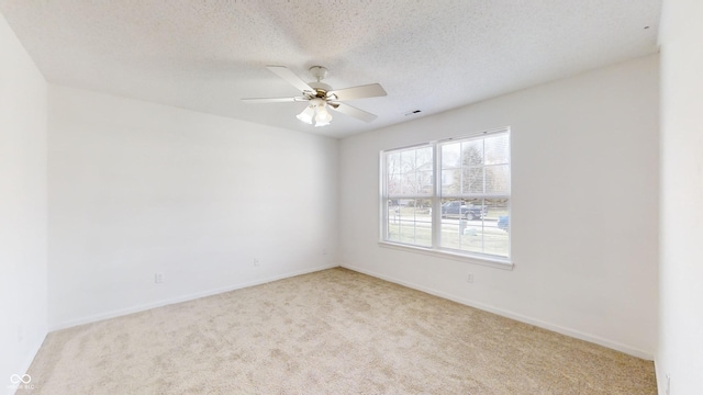 carpeted empty room featuring a textured ceiling and ceiling fan