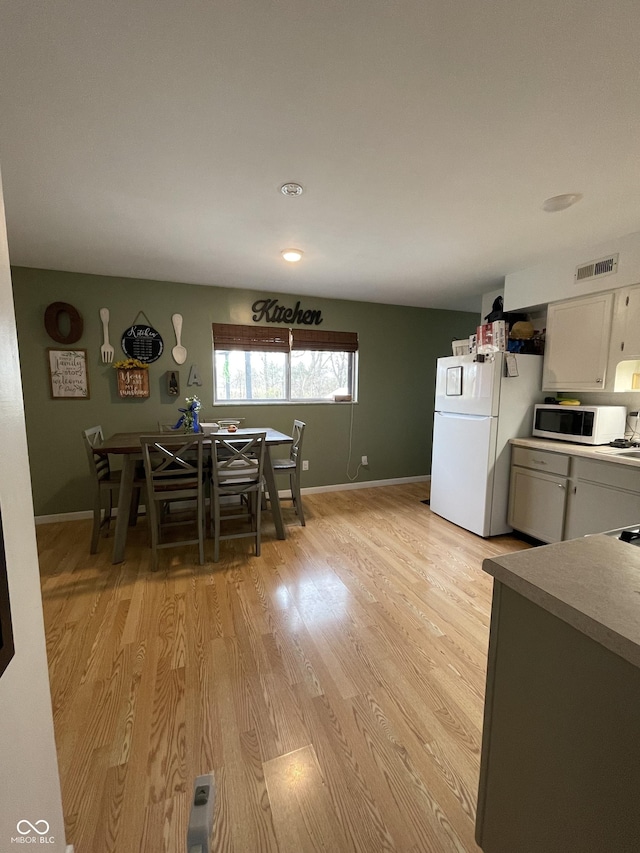 dining area with light hardwood / wood-style floors