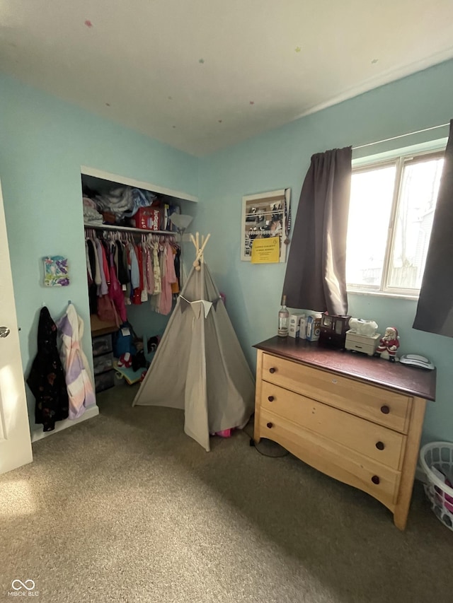 bedroom featuring dark carpet and a closet