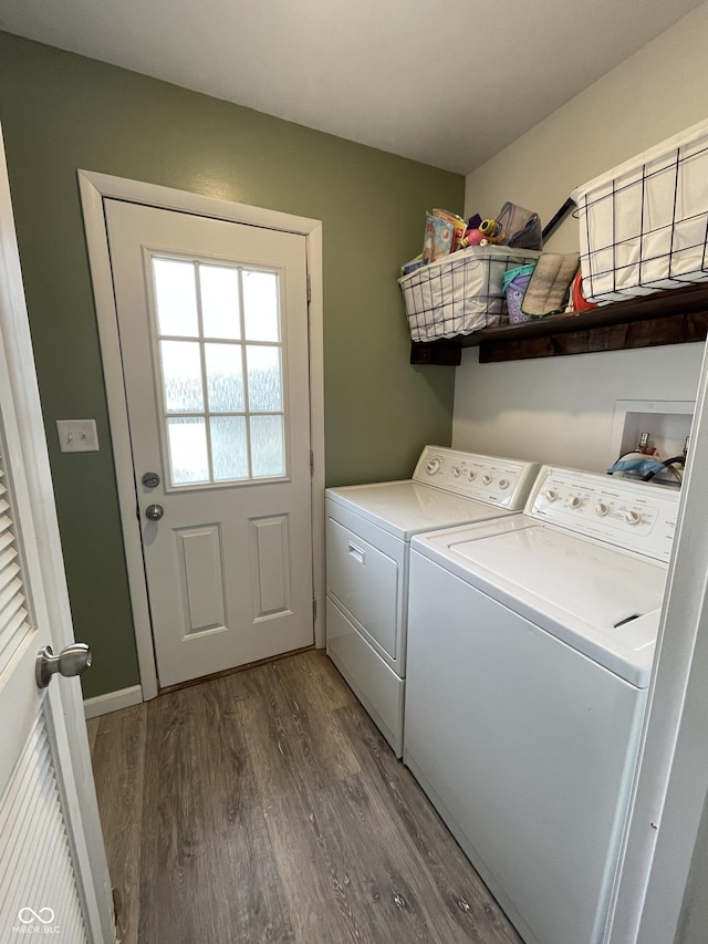 laundry area with dark wood-type flooring and washing machine and clothes dryer