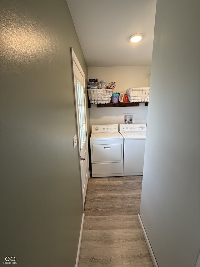 laundry room with light wood-type flooring and independent washer and dryer