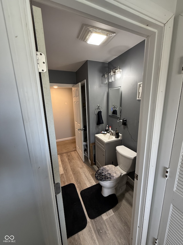 bathroom featuring vanity, toilet, and wood-type flooring