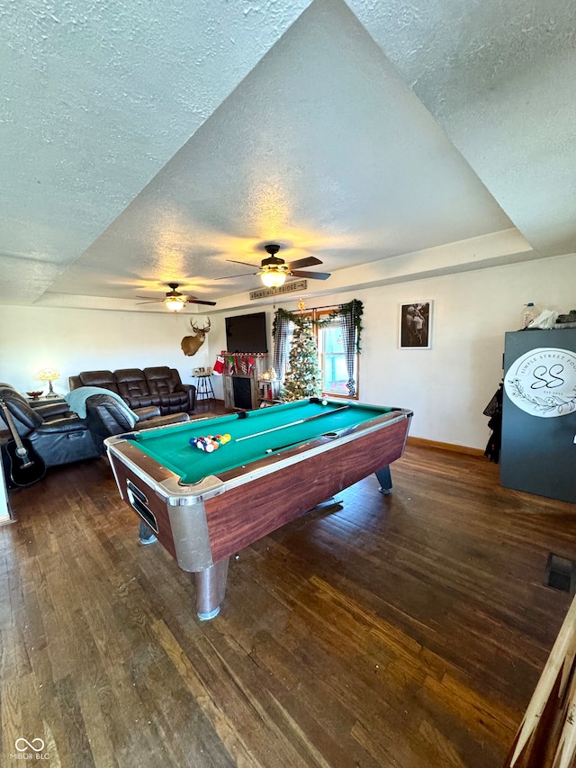 playroom featuring ceiling fan, dark hardwood / wood-style flooring, a textured ceiling, and pool table