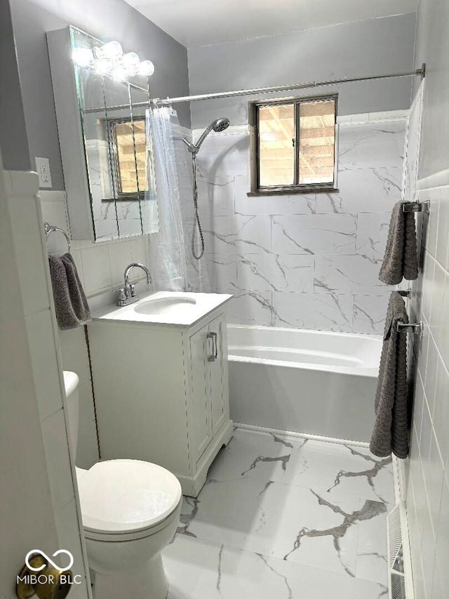 full bathroom featuring vanity, shower / bath combo, and toilet