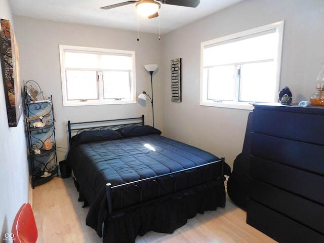 bedroom with light hardwood / wood-style flooring and ceiling fan