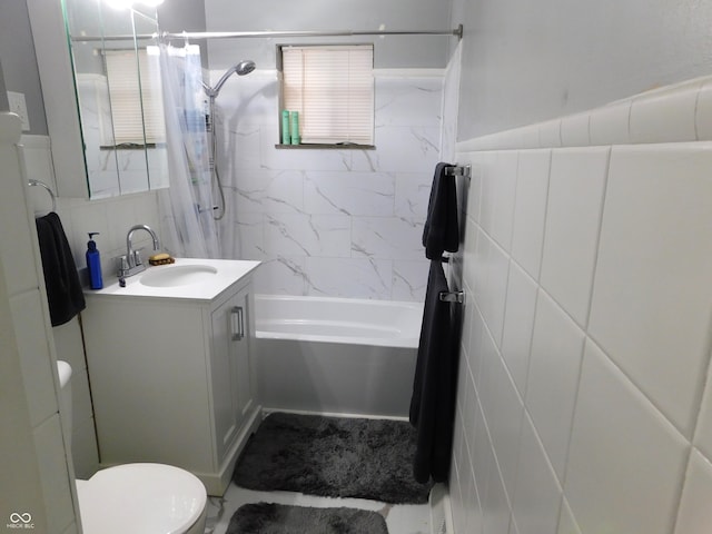 full bathroom with vanity, shower / bath combination with curtain, toilet, and tile walls