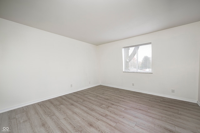 spare room with light hardwood / wood-style floors