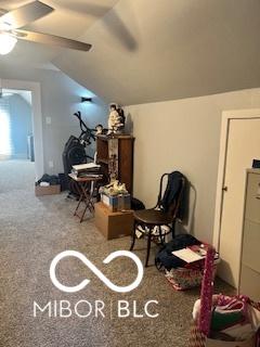 sitting room featuring carpet floors, vaulted ceiling, and ceiling fan