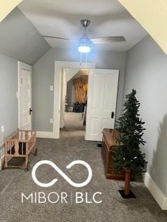 interior space featuring dark carpet and lofted ceiling