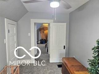 interior space featuring carpet and lofted ceiling