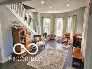 sitting room featuring a textured ceiling and dark wood-type flooring