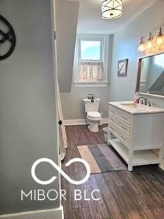 bathroom with hardwood / wood-style floors, vanity, and toilet